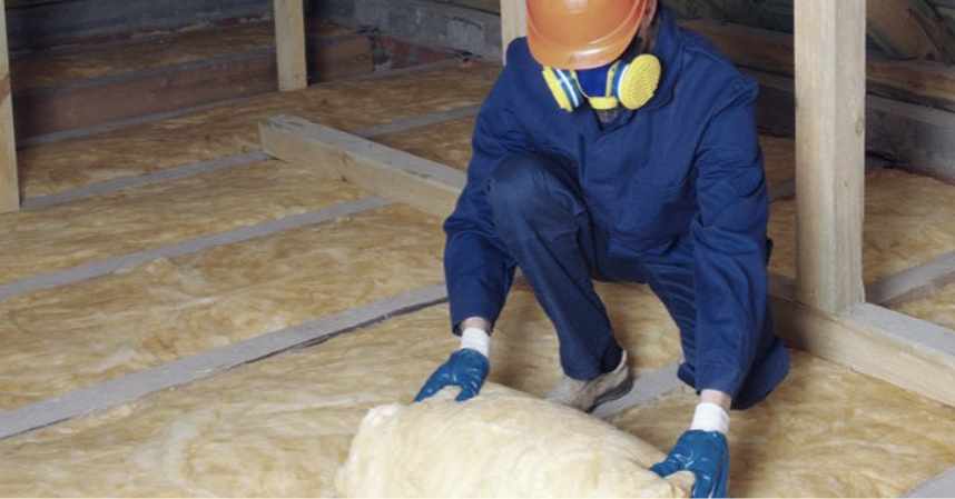 technician repairing attic insulation